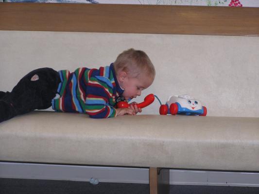 Noah plays with a toy phone.