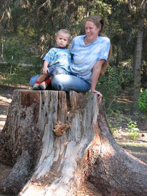 Noah and Katie on a stump at camp