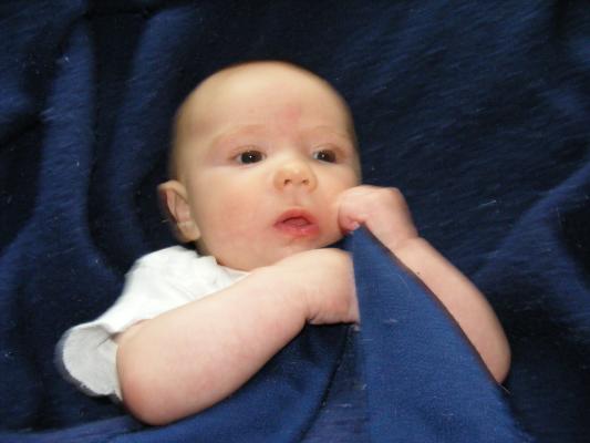 Joshua in a blue blanket.
