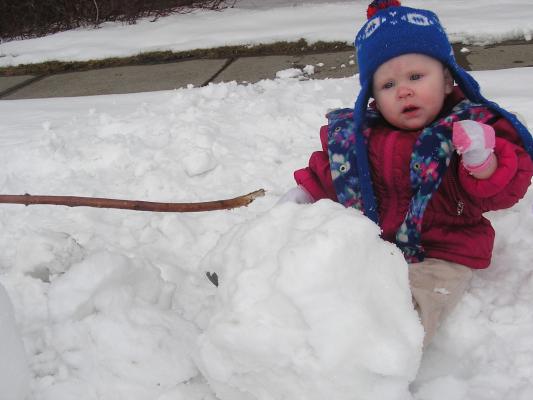 Sarah sits in the snow.