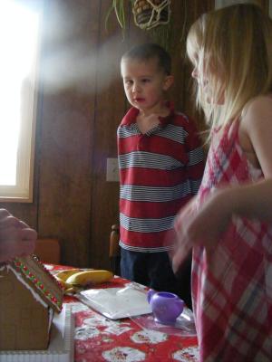 Noah and Sarah make a gingerbread house.