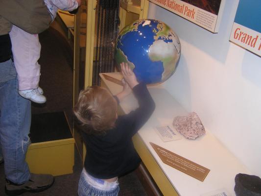 Noah looks at a globe at the Museum of the Rockies.