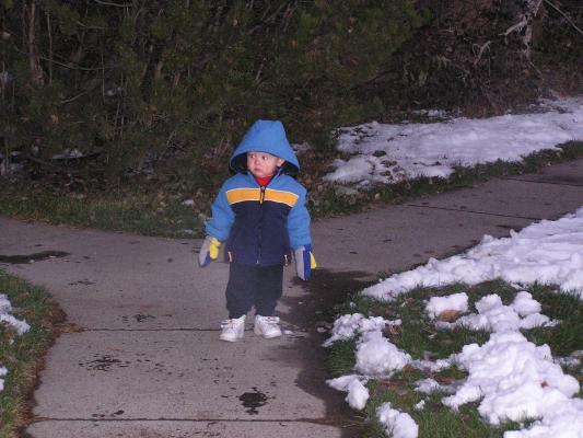 Noah looks at the snowman.