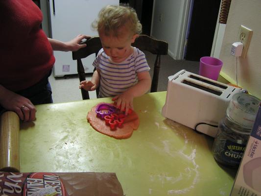 Noah cuts out sugar cookies for Valentines Day.
