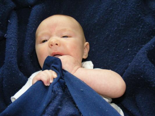 Joshua in a blue blanket.