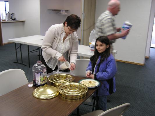 Pam and Malia prepare communion.
The older women teach the younger ...