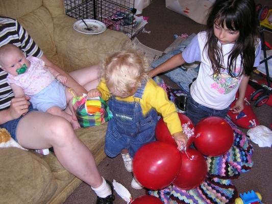 Noah still working at opening the present.