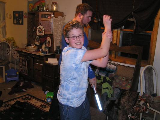 Joe pretends to play the Star Wars game.