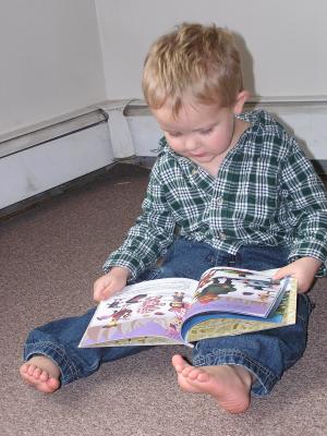 Noah reads Rudolf the Red Nosed Raindeer.