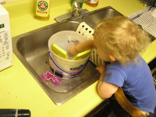 Noah is getting the soap ready for cleaning.