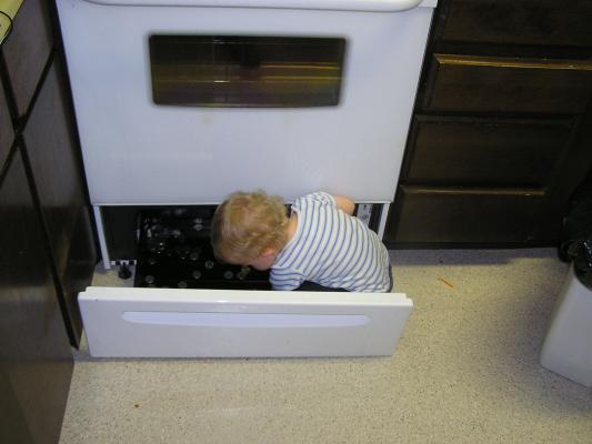Noah plays in the stove.