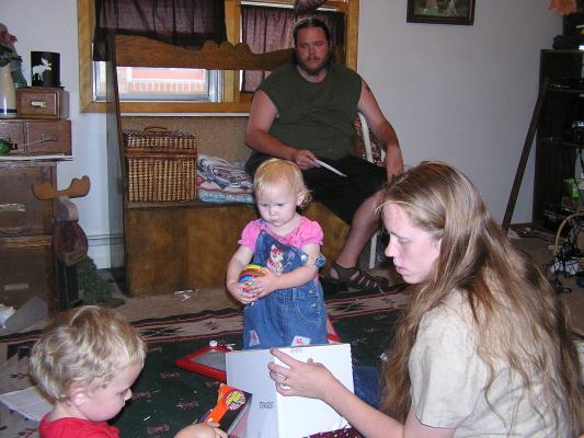 Noah, Sarah and Katie open presents