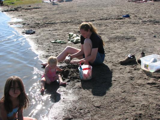 Andrea, Sarah and Katie play in the sand