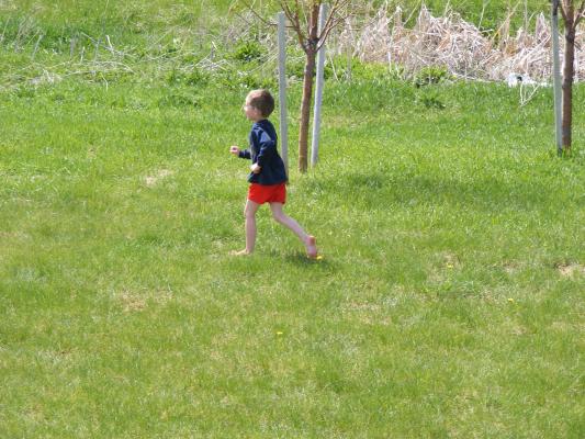 Noah running in the grass.