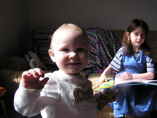 Sarah has her first pigtails. Andrea is reading a book.