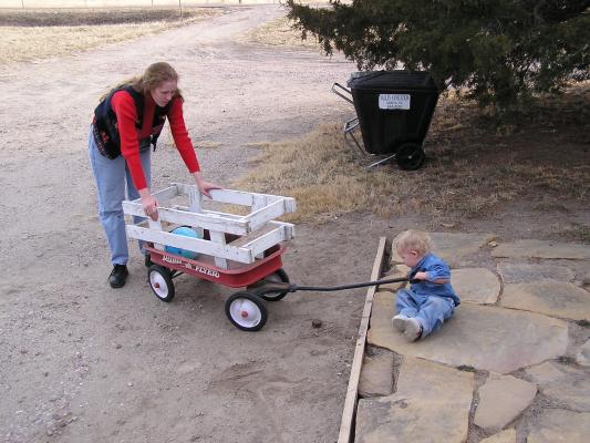 Noah pulls his ball in the wagon.
