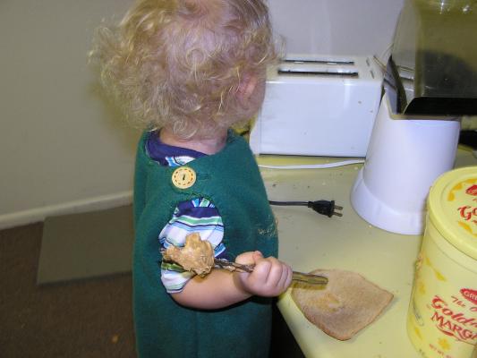 Noah is making a peanut butter sandwich.