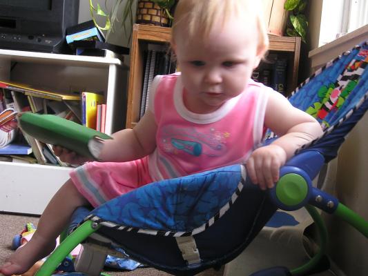 Sarah in her cheerleading outfit sitting in her chair.