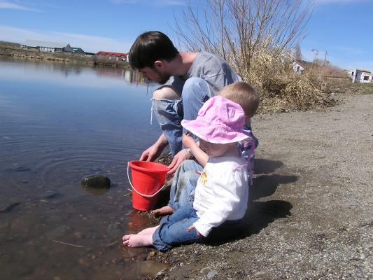 Sarah, Noah and David gather rocks to throw off the dock.