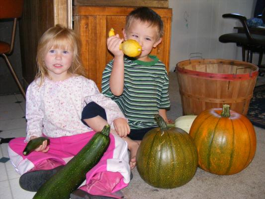 Sarah and Noah display varieties of squash we grew.