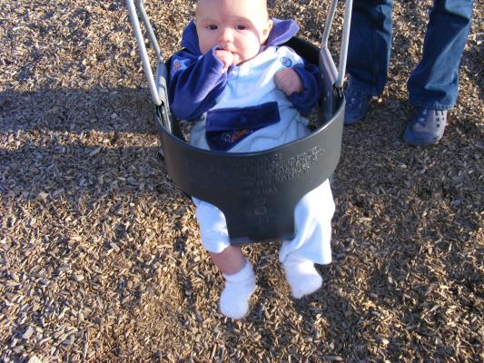 Joshua's first time in a park swing.