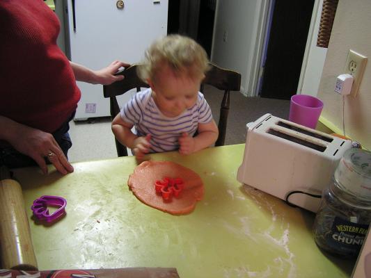 Noah cuts out a ginerbread sugar cookie.