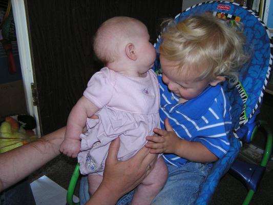 Sarah sits on Noah's lap.