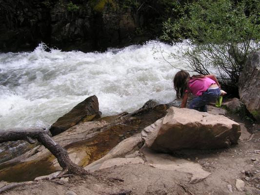 Andrea thows some rocks into the water.