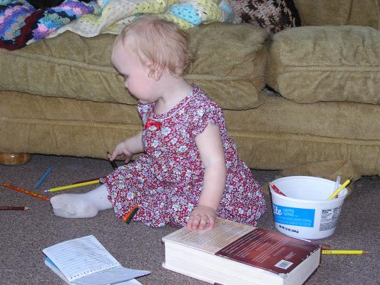 Sarah colors in Noah's Blue's Clues notebook.