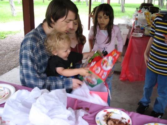 Noah opens his birthday present from Robert's family.