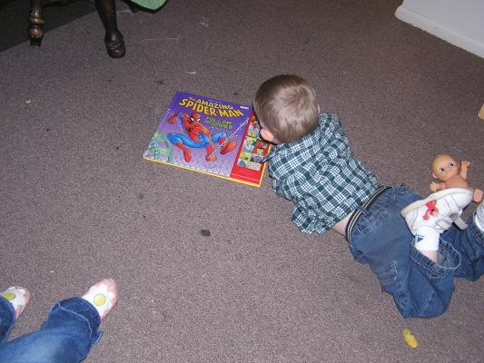 Noah plays with his new Spiderman book.
