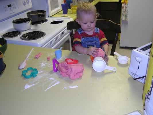 Cookie cutters, measuring cups, spoons and play dough.