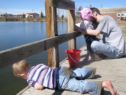 Noah and Sarah throw rocks off the dock.
