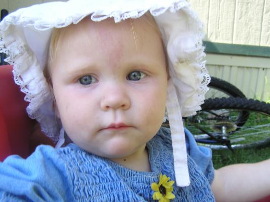 Sarah in a hat in the wagon