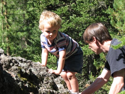 Noah and David climb a rock