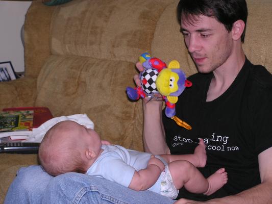 Noah watches the monkey on David's lap.