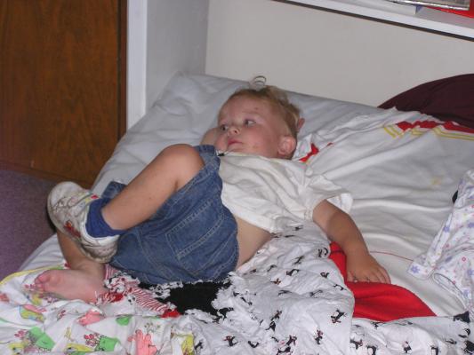 Noah plays in his bed.