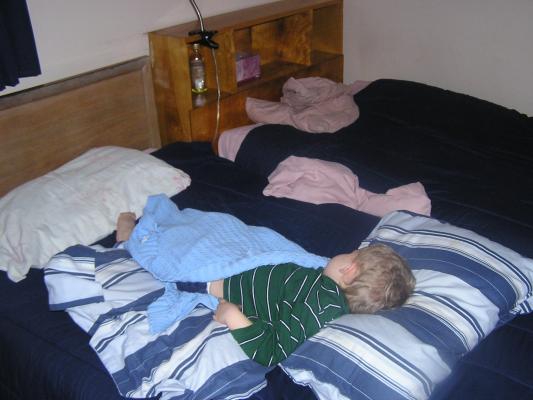 Noah sleeping on Grandma and Grandpa's bed.