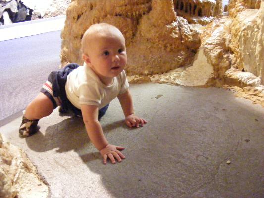 Joahua is playing while his daddy and siblings go through the real cave.