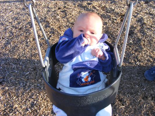 Joshua's first time in a park swing.