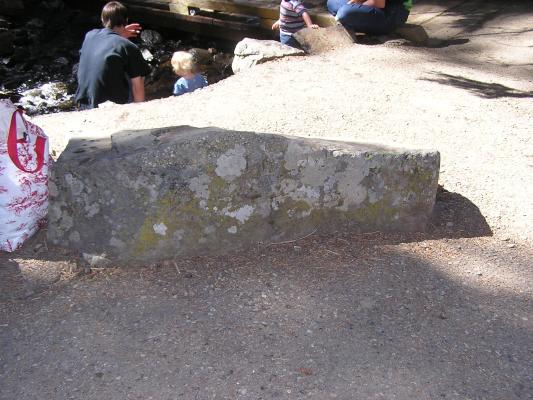 A rock with DAvid and Sarah in the background