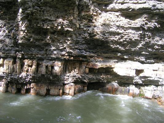 Sedimentary rock formations along the bank of the river.