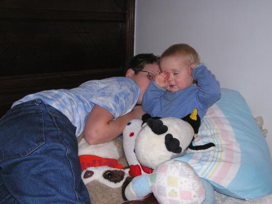 Joe tries to burry Noah in stuffed animals.