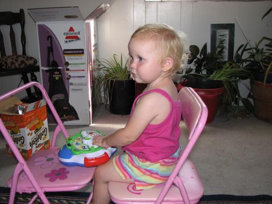 Sarah plays with the ABC Toy on the pink chairs.