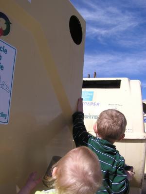 Sarah and Noah need a boost to reach the recycling container.