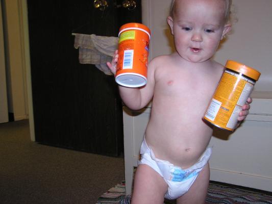 Noah plays with the fish food.