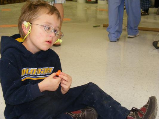 Noah eats a pumpkin candy.