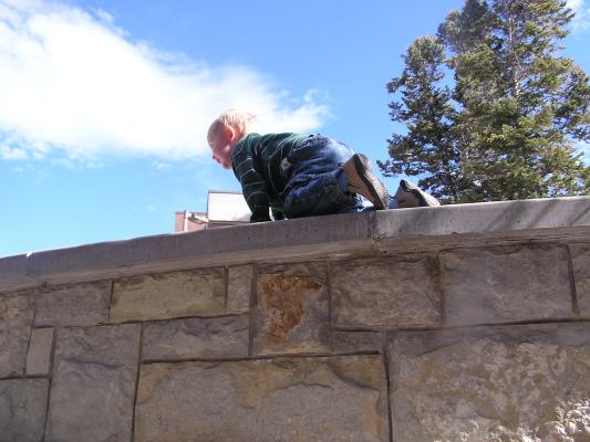 Noah climbs the wall.