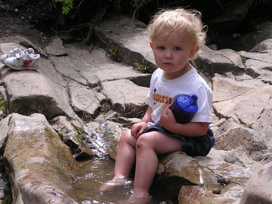 Noah plays in the water at the top of Ousel Falls.
