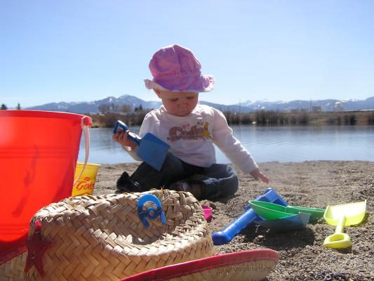 Sarah plays in the sand at the beach.